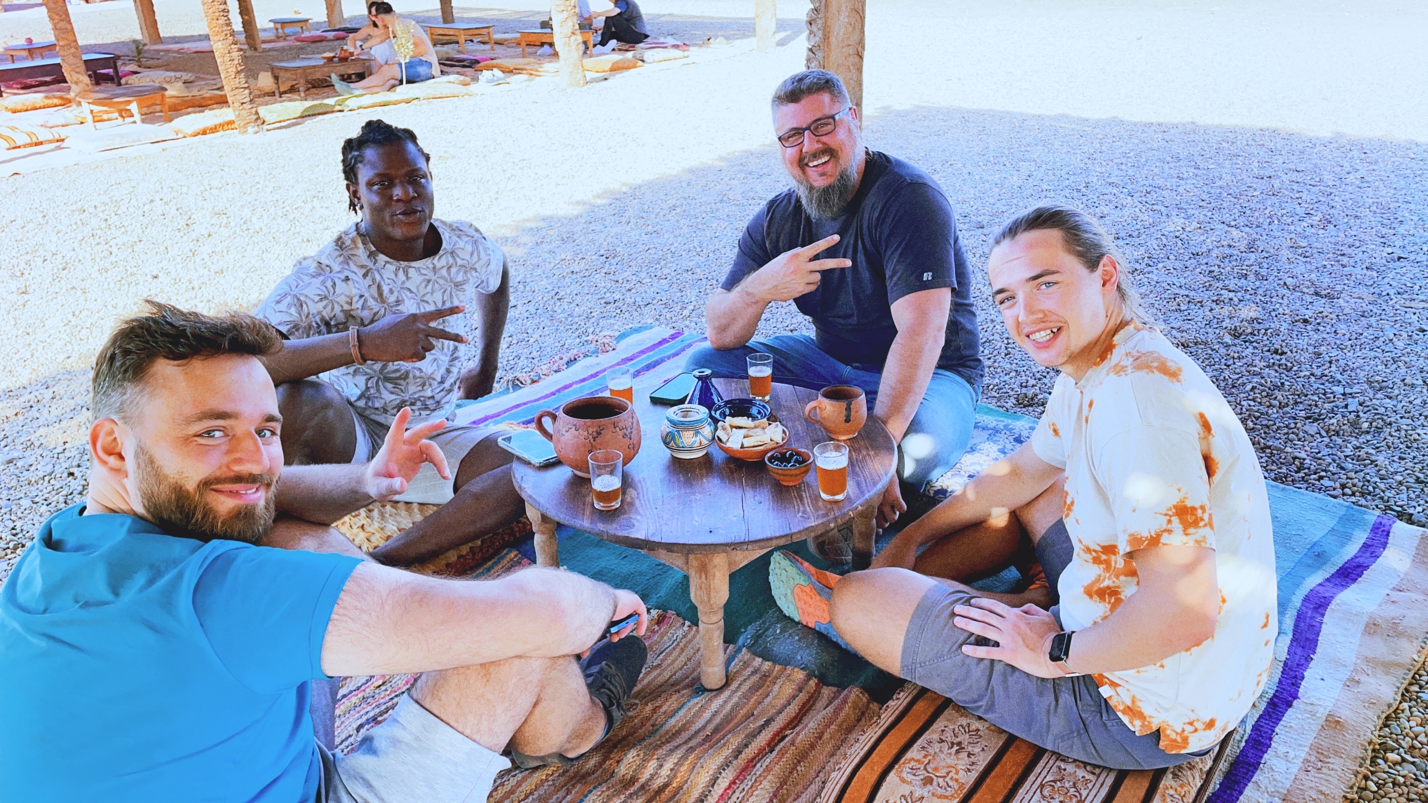 Jakub Towarek sitting with three members of the Dispo team in Marrakech, Morocco