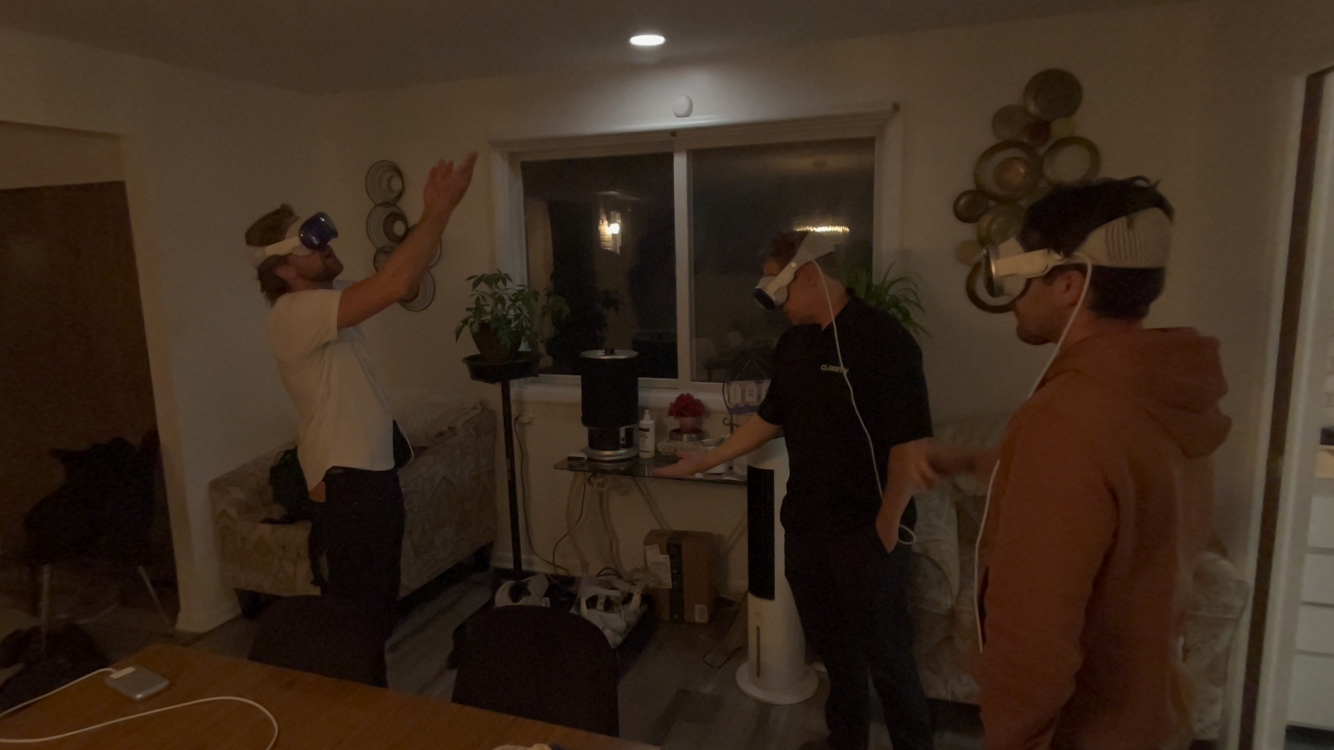 Jakub Towarek and two teammates wearing mixed-reality headsets while preparing an Apple Vision Pro client presentation in Chicago